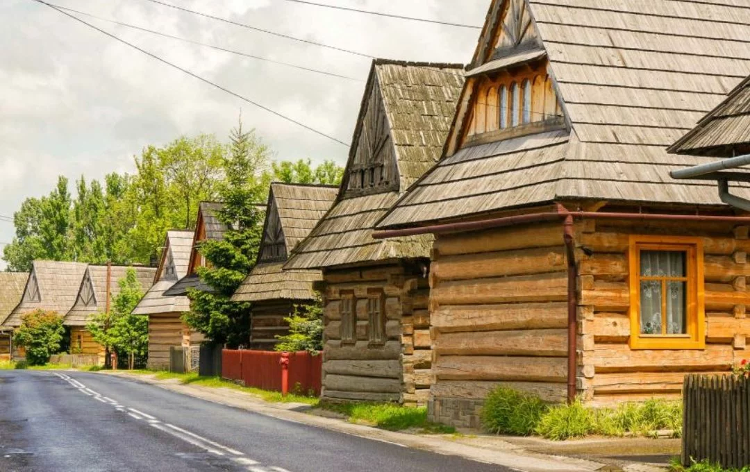 Traditional wooden log houses on the street in Chochołów highland village