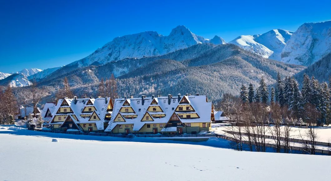 Zakopane winter panorama at dusk with Tatra mountains and city lights